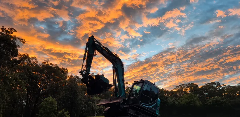 One of our excavators loaded on the float at sunset